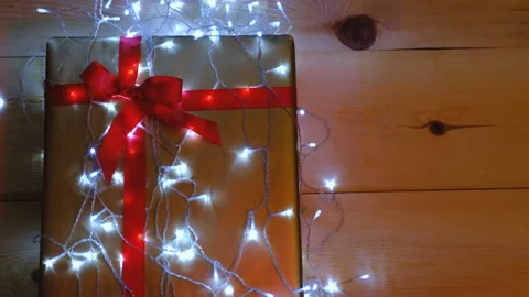 Flashing led light effects on gift wrap with red ribbons. Vídeo Stock 142078871