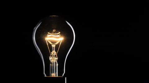  Flashing light bulb over black background Stock Footage 65455443