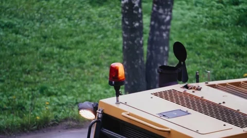 Flashing light on the cab of road construction equipment Stock Footage 213723762