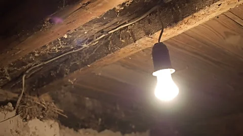 Flashing lightbulb In the old basement of the house Stock Footage 67830573