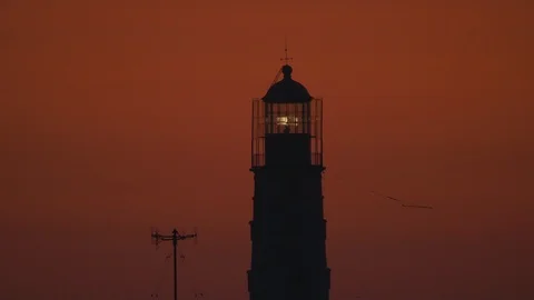 Flashing lighthouse on sunset background Stock Footage 119884486