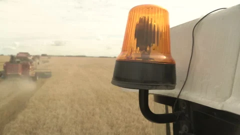 Flashing lights on the storage bin of the combine harvesting corn Stock Footage 169139729
