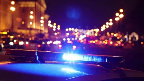 Flashing lights of a traffic police car and night city street Stock Footage