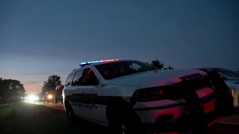 Flashing red and blue emergency lights on a police patrol vehicle at dusk. Law Stock-Footage 340541145