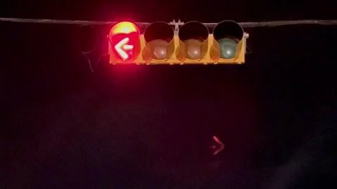 Flashing red stop lights arrow at night in Austin, Texas on 9-28-2025 Stock Footage 317937891