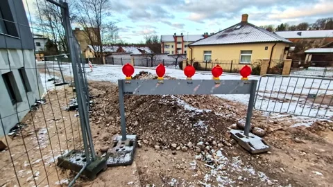 Flashing red warning lights on a road work barricade signaling danger in winter Stock Footage 342770775