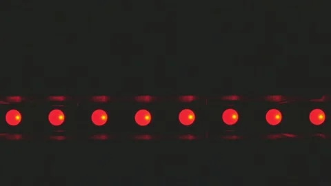 Flashing stage wall made of halogen lamps glows brightly in different colors Vídeo Stock 184471260