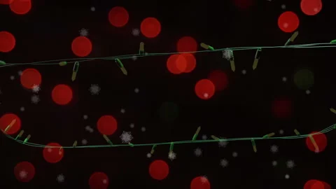 Flashing yellow christmas string lights and red bokeh light spots over falling Stock Footage 310924752