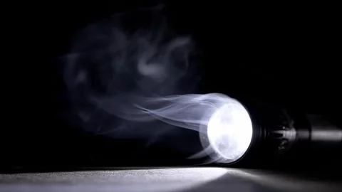 Flashlight Beam Illuminating Swirling White Smoke In Darkness 库存影片 330115546