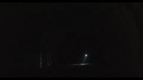 Flashlight beam pointing directly at the camera in a dark tunnel Stock Footage 339864361