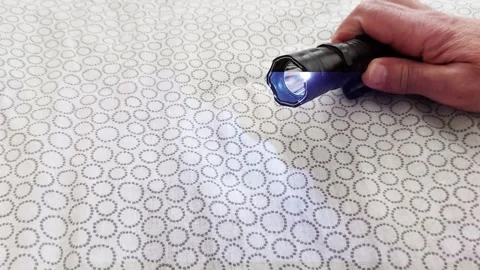 Flashlight Brightness Test on Patterned Surface Stock Footage 310933545