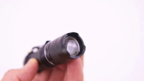 Flashlight flash light tactical hand holding macro closeup white background Stock Footage 249341940