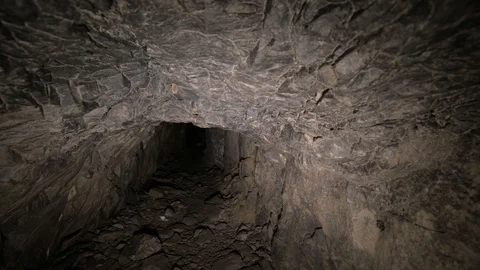 Flashlight illuminates dark passage in cave. Graffiti. Old abandoned mine. Stock Footage 123470805
