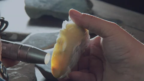 The flashlight illuminates the jade to check the impurities inside，China Stock Footage 140766452
