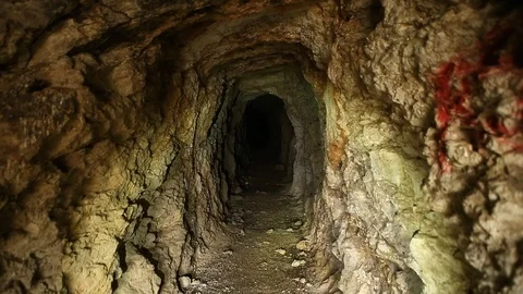Flashlight illuminating inside of abandoned gold mine Stock Footage 122903331