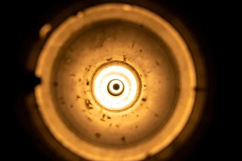 Flashlight light in an empty used anti-tank grenade launcher as a backgroun.. Stock Photos
