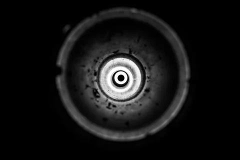Flashlight light in an empty used anti-tank grenade launcher as a backgroun.. Stock Photos