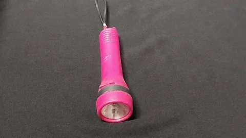 The flashlight for lighting is pink Stock Footage 224795219