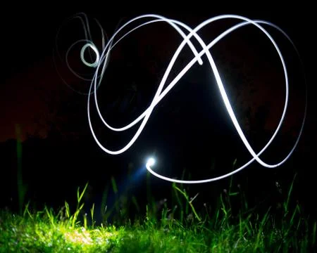 Flashlight making illuminated light effects in the darkness Stock Photos