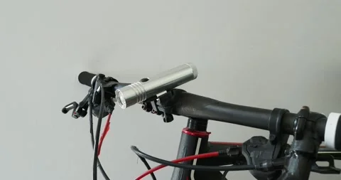 Flashlight mount on handlebar in bicycle. Stock Footage 217414277