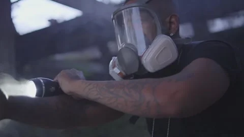 A flashlight passes the screen in a smokey abandoned building to reveal a Stock Footage 255565154