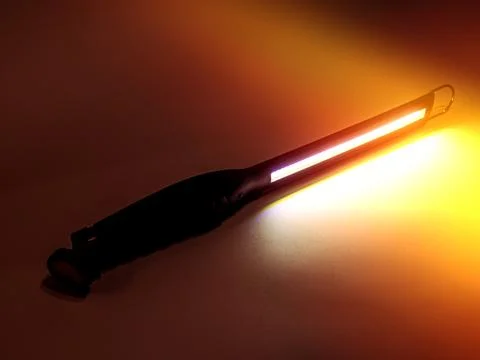 Flashlight. studio lighting. against the background a black flashlight with.. Stock Photos