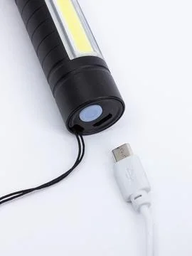 Flashlight with USB charging cable detail Stock Photos