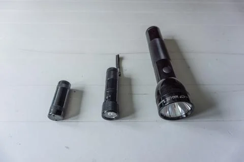 Flashlights arranged on size on white background Stock Photos