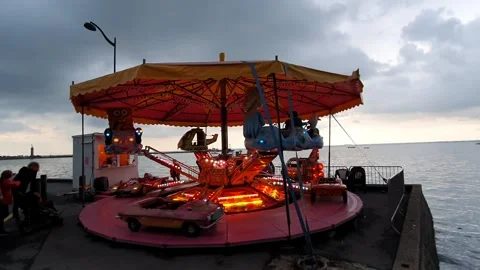 A flashy carousel during a fair by the sea Stock Footage 158997612