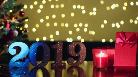 Flashy Light Effect on 2019 and Gift boxes with Christmas Tree with Bokeh Bac 動画素材 98538625