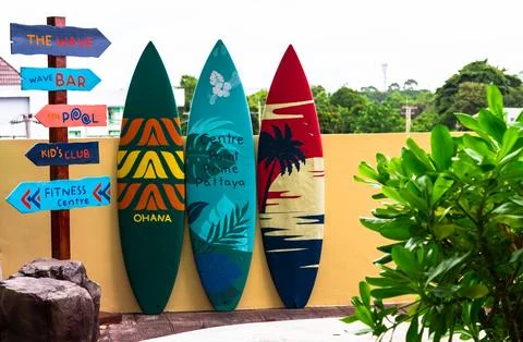 Flashy pattern surfboard and road sing. Stock Photos