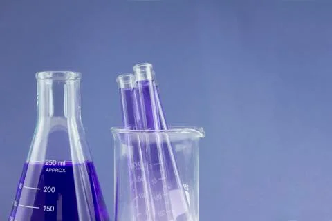 Flask and test tubes in beaker Stock Photos