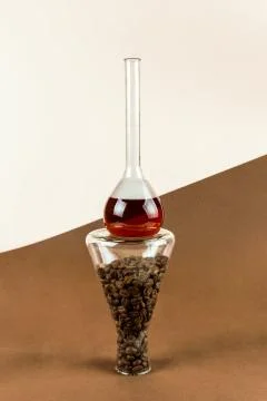 Flask with coffee on conical glassware with beans, selective focus, alternati Stock Photos
