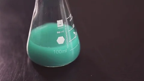 Flask with a light green Stock Footage 76342387