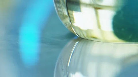 A flask with liquid on a table Stock Footage 72636990