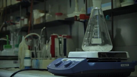 Flask with reagent spin in laboratories Stock Footage 101414991