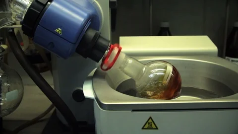 Flask with reagent spin in laboratories Stock Footage 101415105