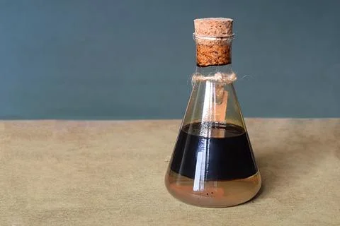 A flask with a sample of oil. Stock Photos