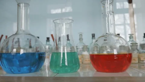 Flasks with chemical in laboratory. Cropped hands of scientist taking flask Stock Footage 85984005