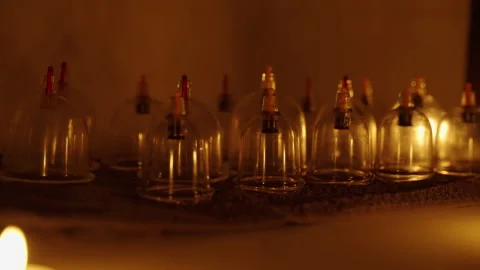 Flasks for massage on the background of candles. Spa salon, details for massage. Stock Footage 246632245