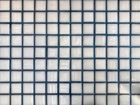 Flat, abstract mosaic wall with a grid pattern of square tiles Each tile sh.. Stock Photos