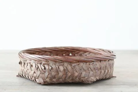 Flat basket on wooden table Stock Photos