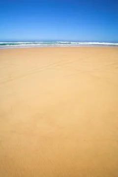 Flat beach with blue sky Stock Photos