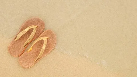 Flat beach flip flops on the background of yellow sand and sea waves Stock Photos