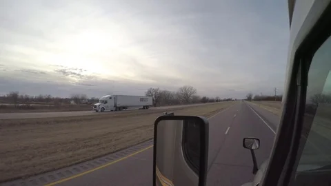 Flat-Bed Semi-Truck Passing on the Left in Rural Nebraska Stock Footage 70691405