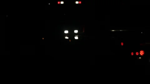 Flat bed wrecker with work lights and flashers at night Stock Footage 94523781