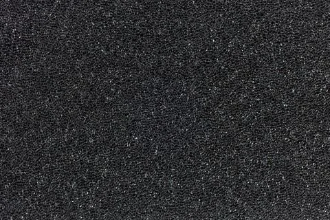 Flat black foam rubber sponge texture and background Foto stock