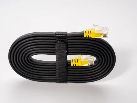Flat black network cable on a white background. Stock Photos