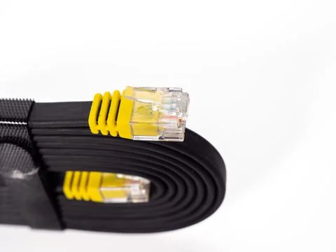 Flat black network cable on a white background. Stock Photos