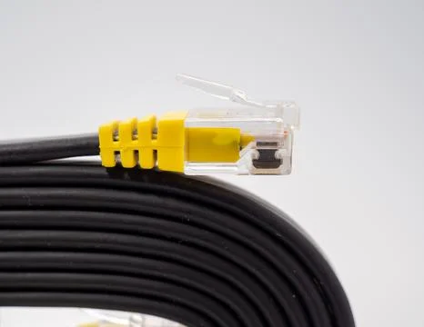 Flat black network cable on a white background. Stock Photos